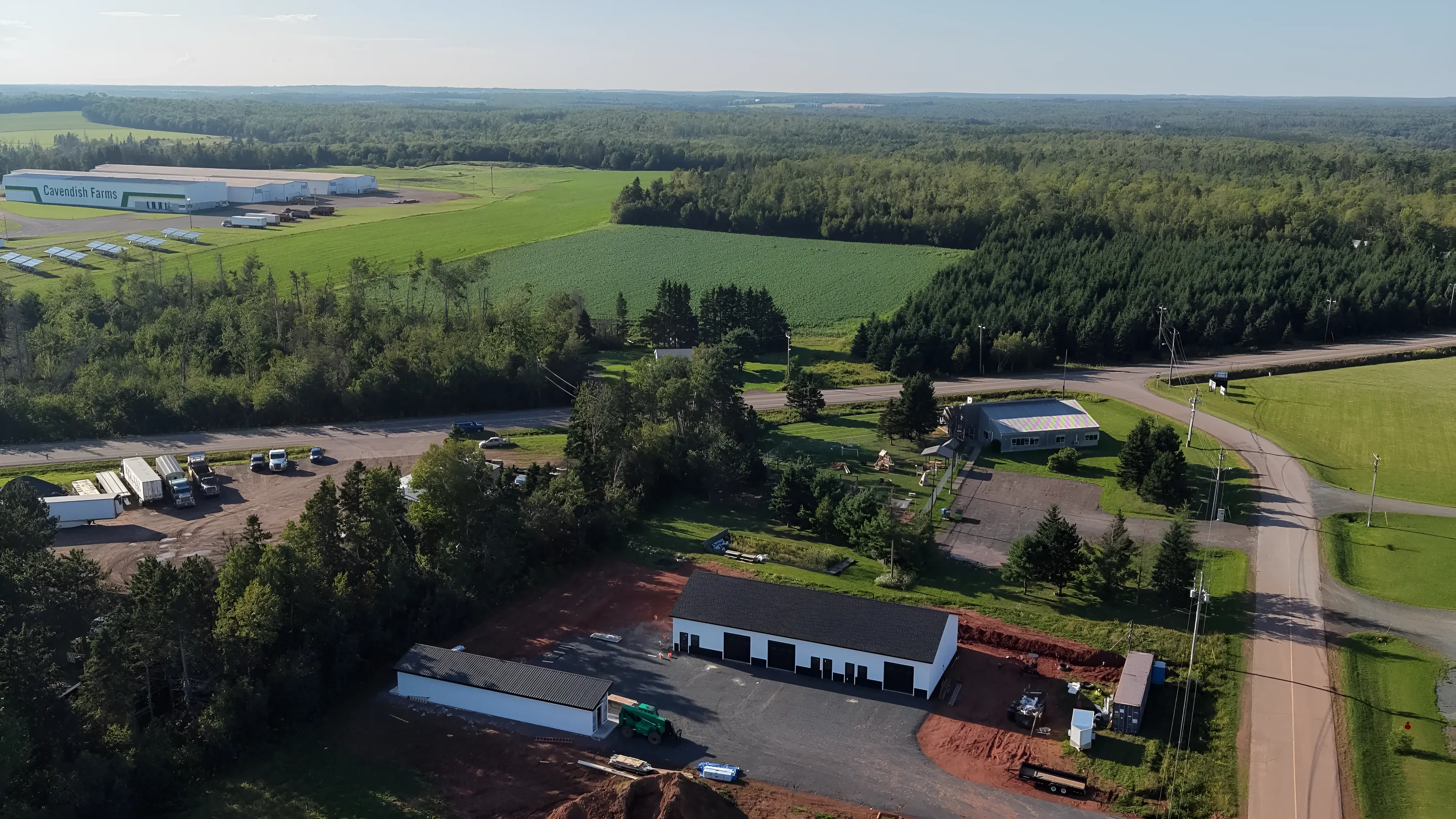 Pooles Corner Business Park from the air: the commercial plaza and the storage building among fields and woods