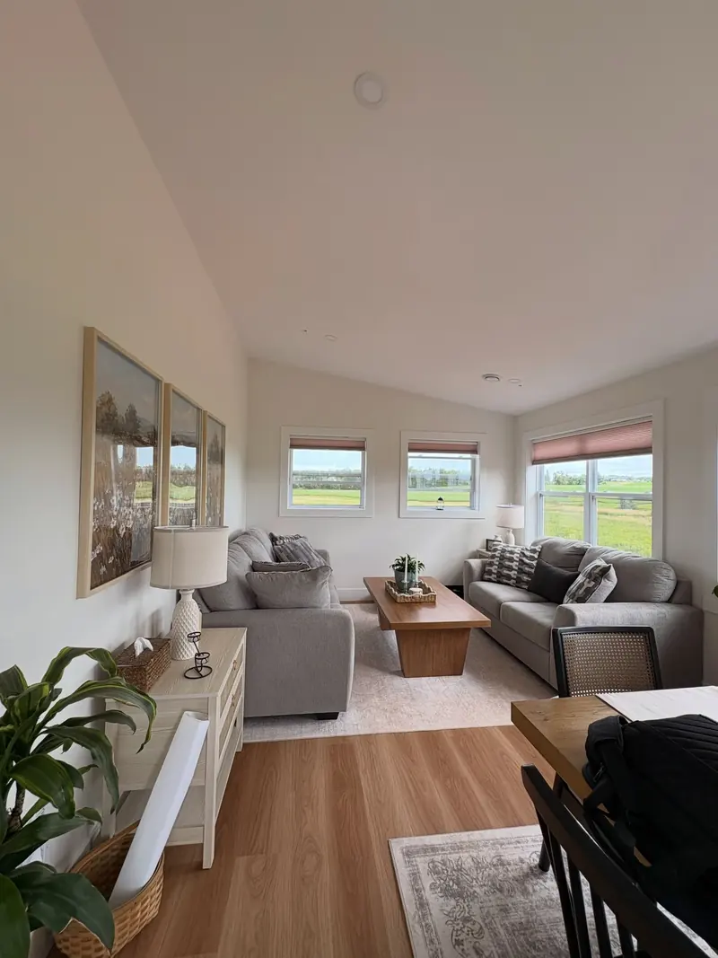 A bright living room with wide plank floors